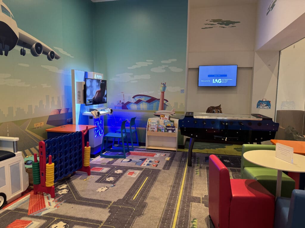 a room with a table and chairs and a television