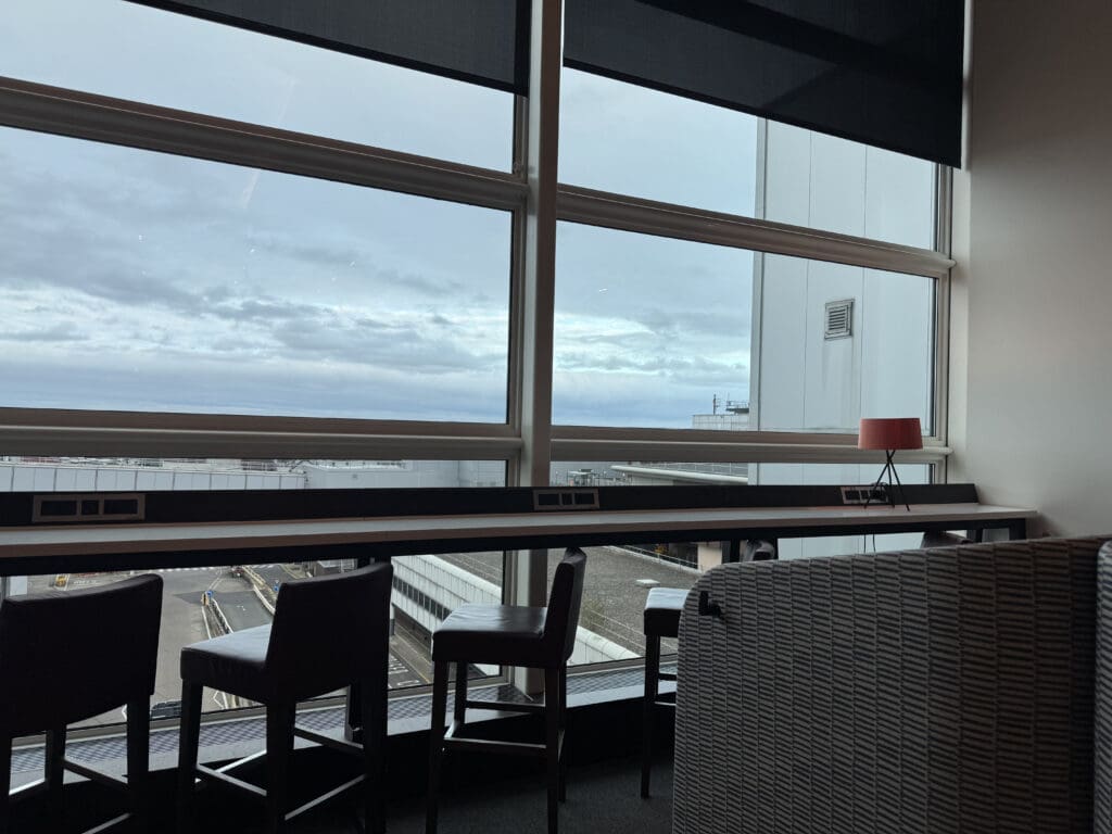 a window with a view of a road and a city