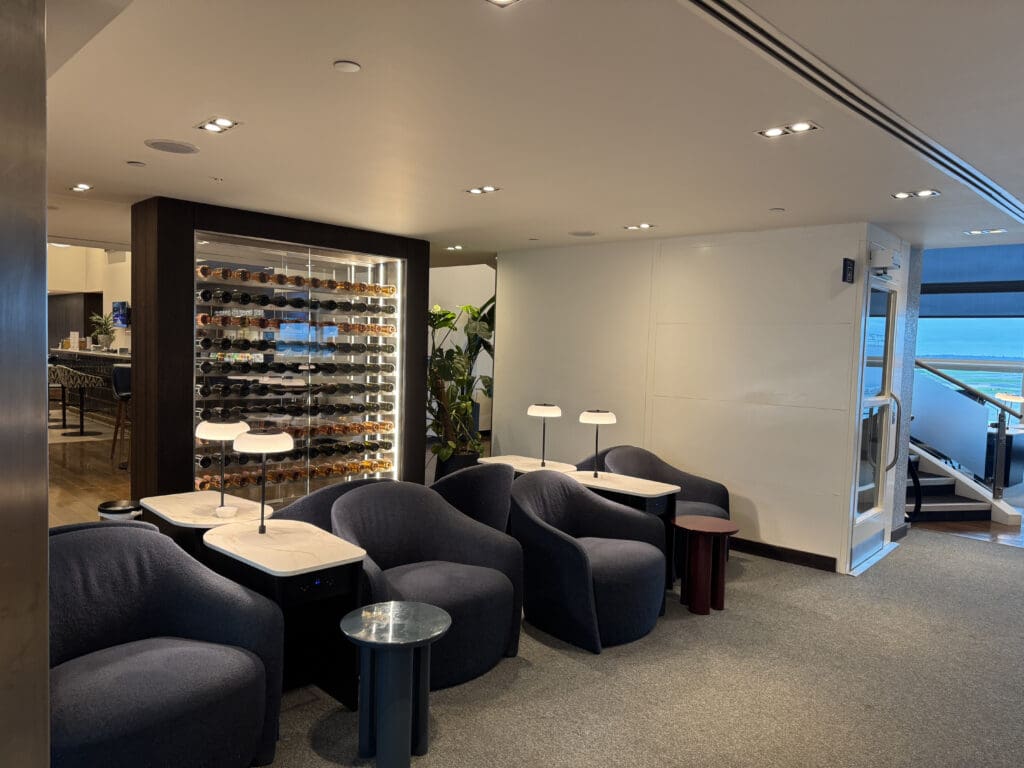 a room with chairs and a display of glasses