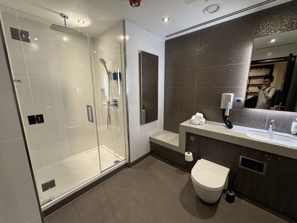 a bathroom with a glass shower and sink