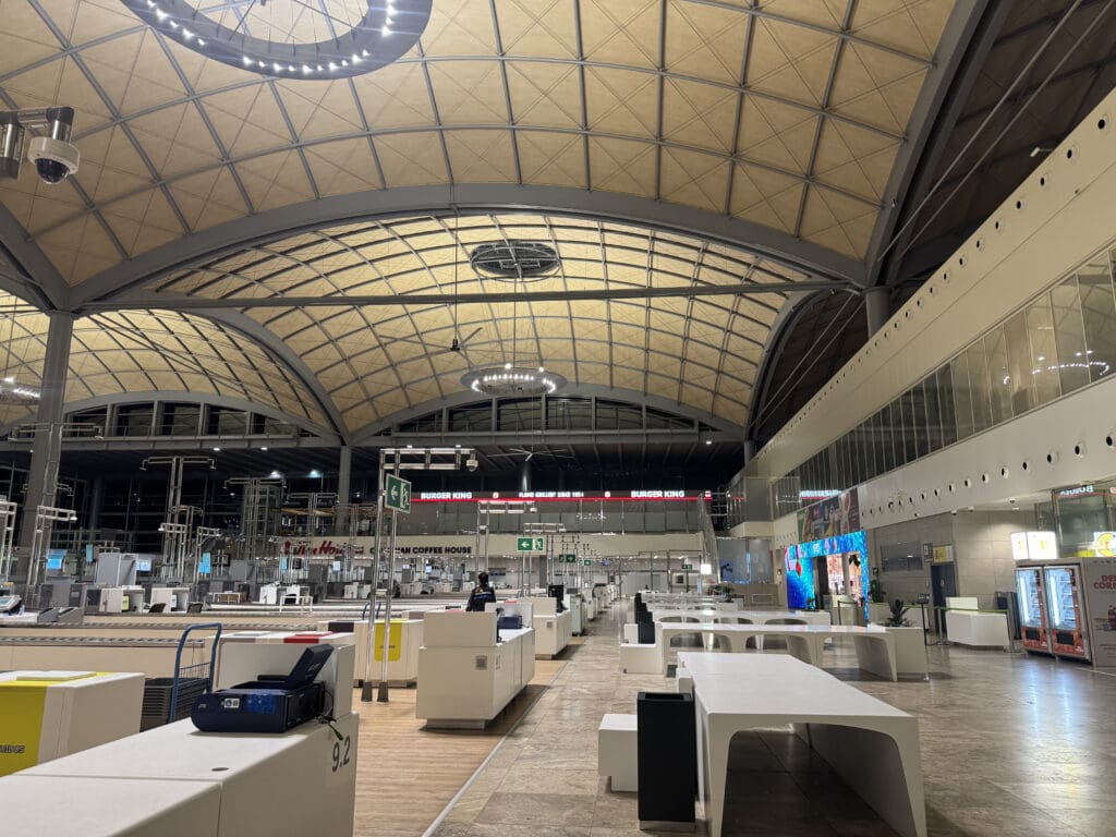a large building with white tables and a large ceiling