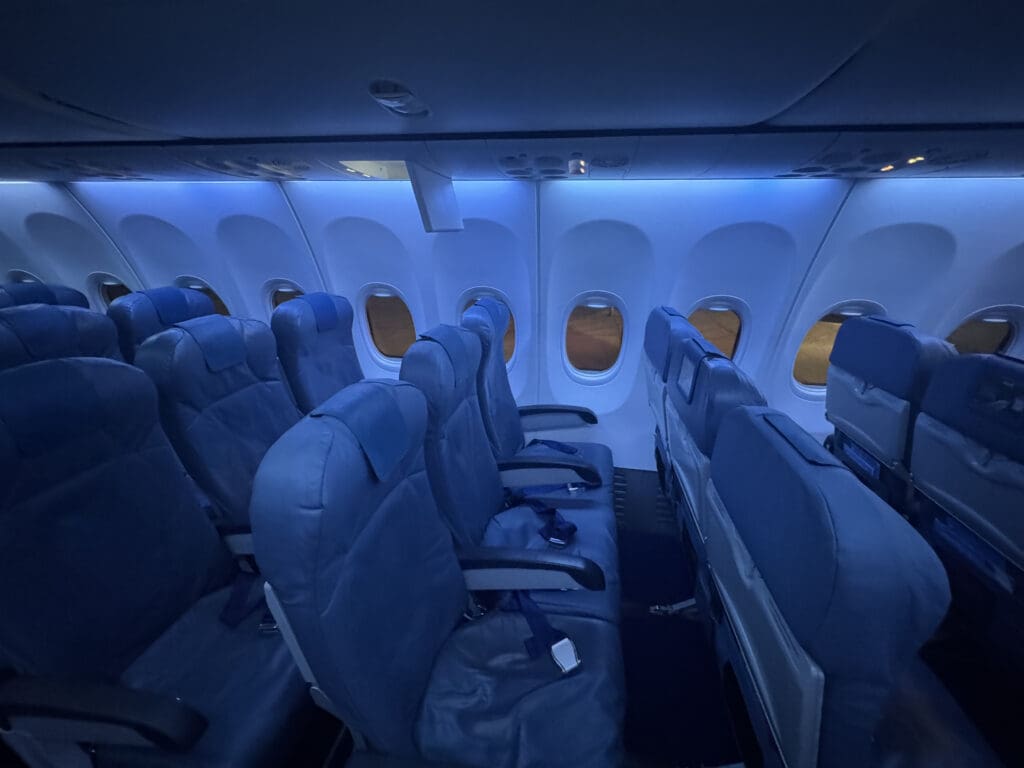 the inside of an airplane with seats and windows