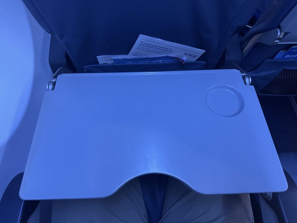 a blue seat on a bed