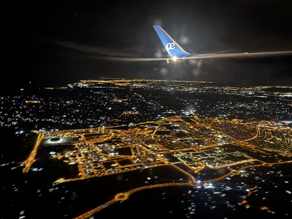 an airplane flying over a city at night
