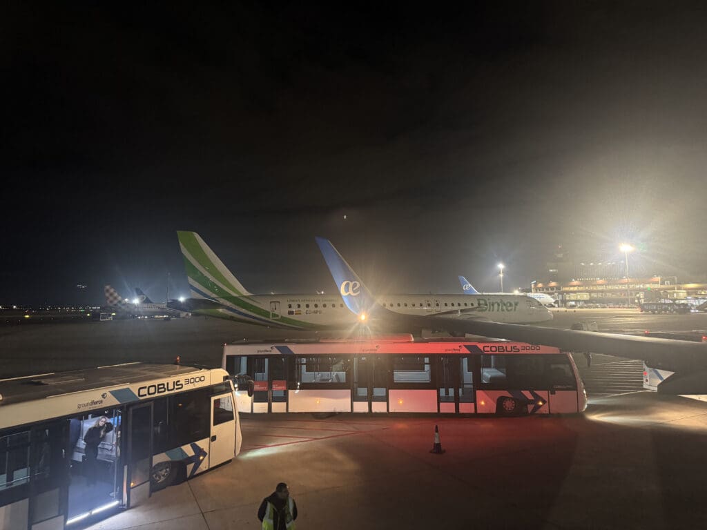 a group of airplanes at a terminal