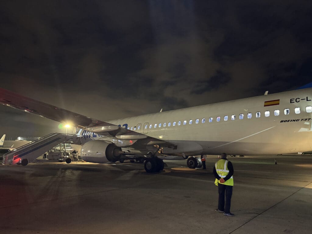 a man standing in front of a large airplane