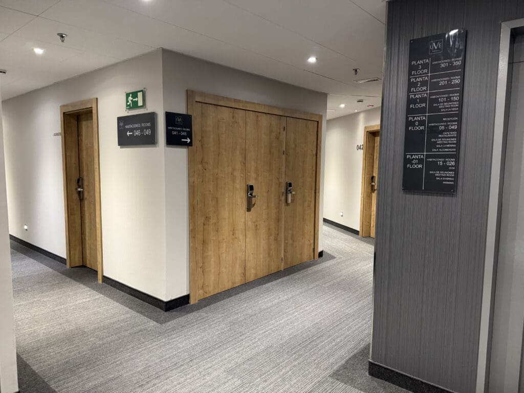 a room with wooden doors and signs