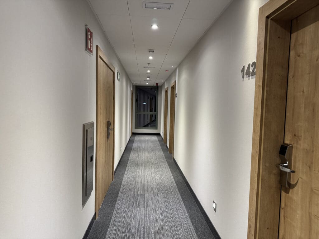 a hallway with doors and a door on the wall