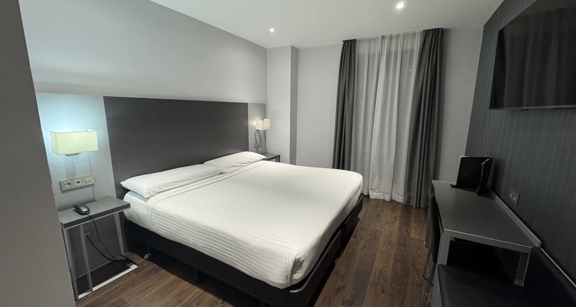 a room with a bed and a tv