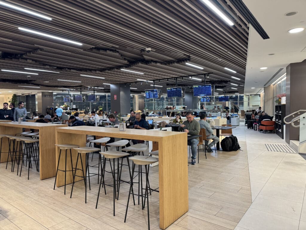 people sitting at tables in a large room