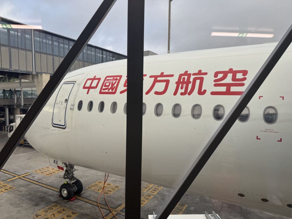 a white airplane with red writing on it