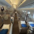 a plane with seats and people in the background