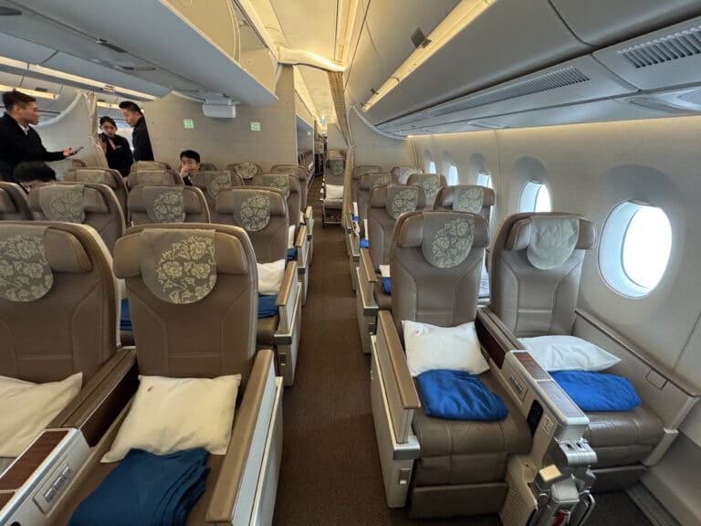 a plane with seats and people in the background