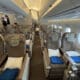 a plane with seats and people in the background