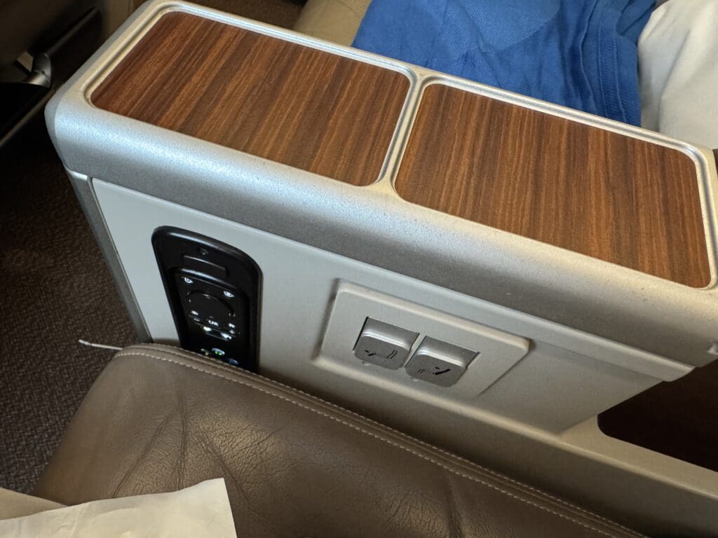 a seat with a wood panel and buttons