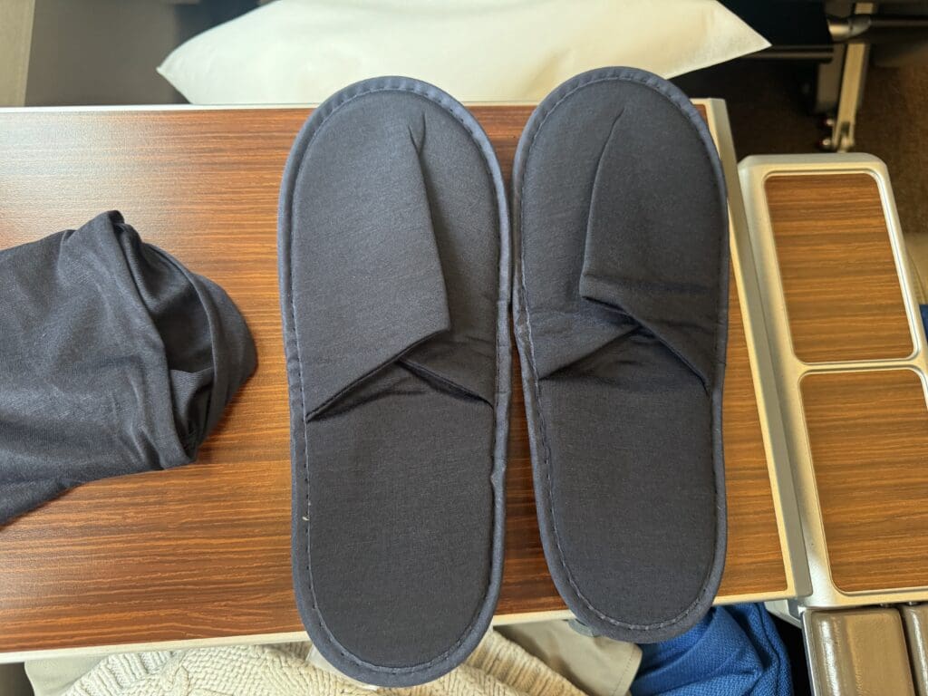 a pair of black slippers on a table