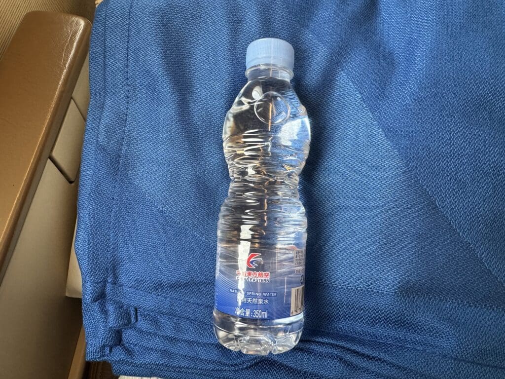 a bottle of water on a blue towel