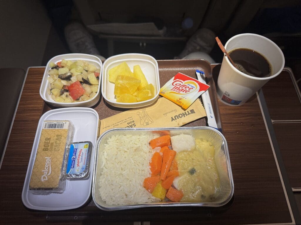 a tray of food and a cup of coffee