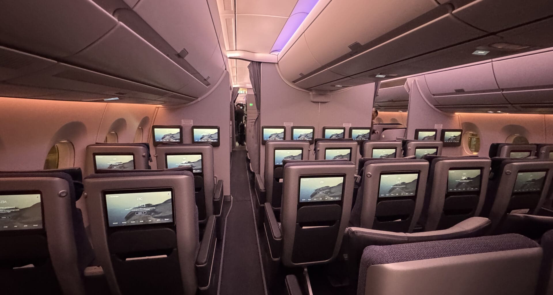 a row of seats with monitors on the side