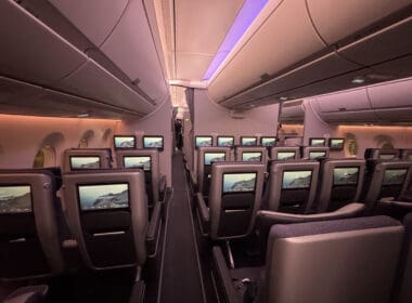 a row of seats with monitors on the side