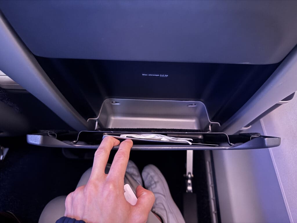 a hand holding a paper in a tray