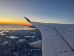 an airplane wing above a body of water