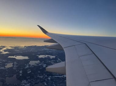 an airplane wing above a body of water