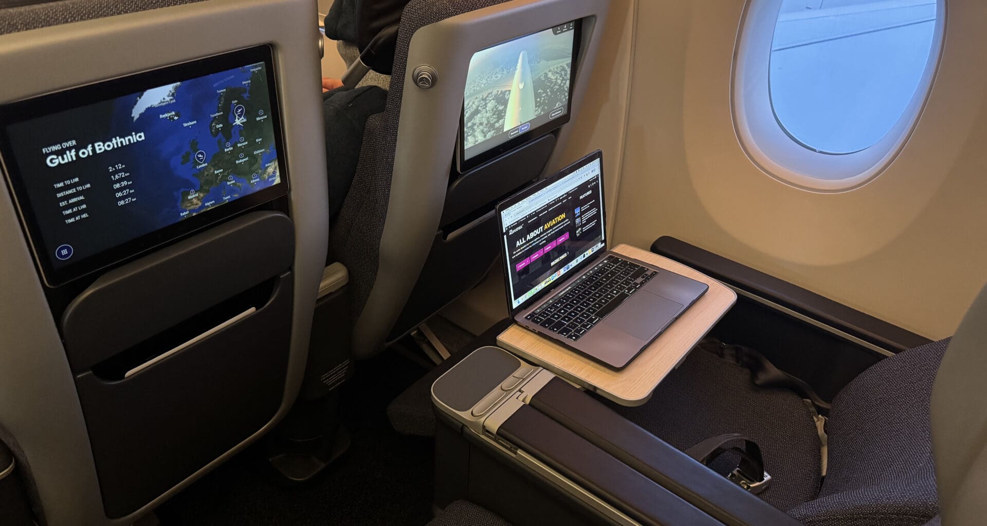 a laptop on a table in an airplane