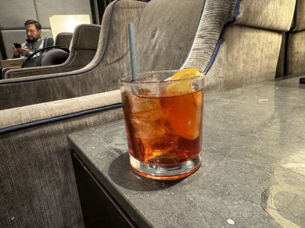 a glass of ice tea with a straw on a table