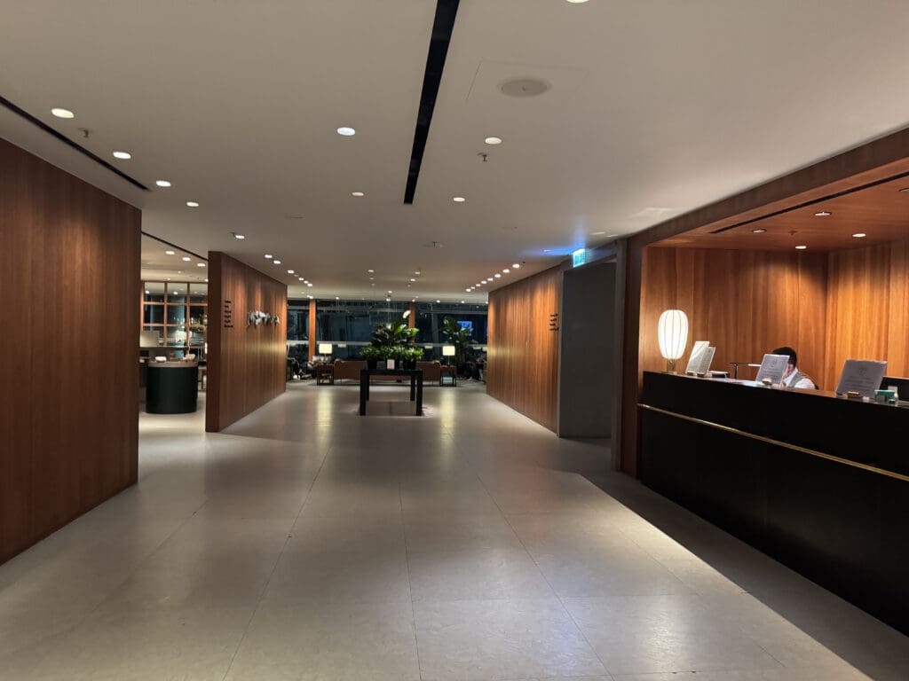 a hallway with a reception desk and a table