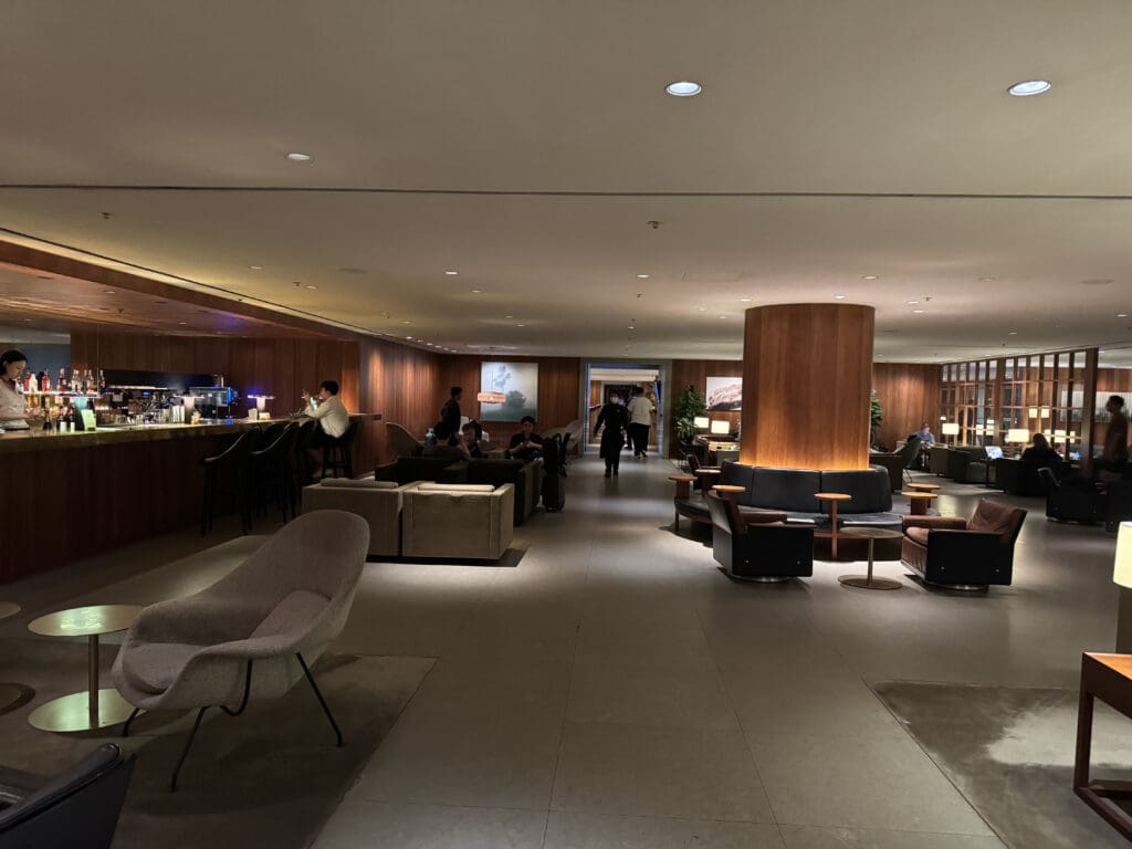 a room with a large area with a large counter and chairs