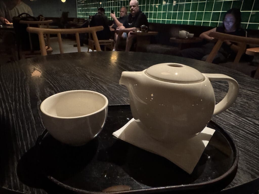 a teapot and cup on a tray