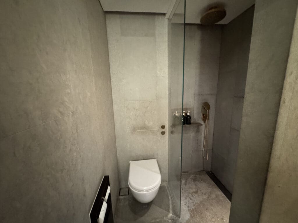 a bathroom with a glass shower door