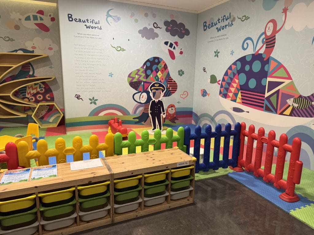 a room with colorful toys and a wall mural