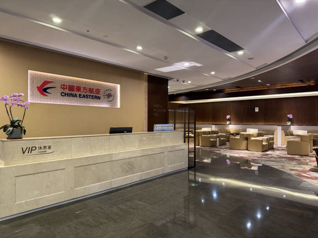 a lobby with a sign and chairs