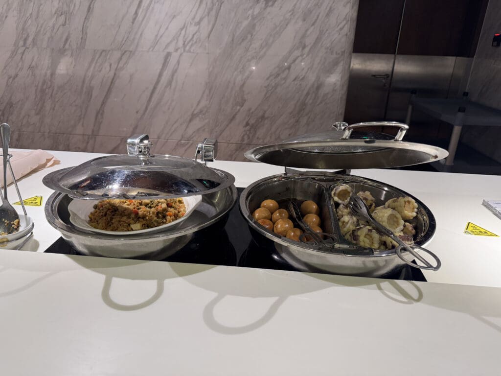 a two metal bowls with food in them