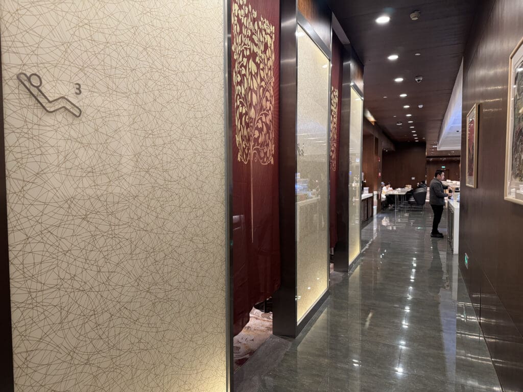 a room with a wall and a couple of people standing in front of it