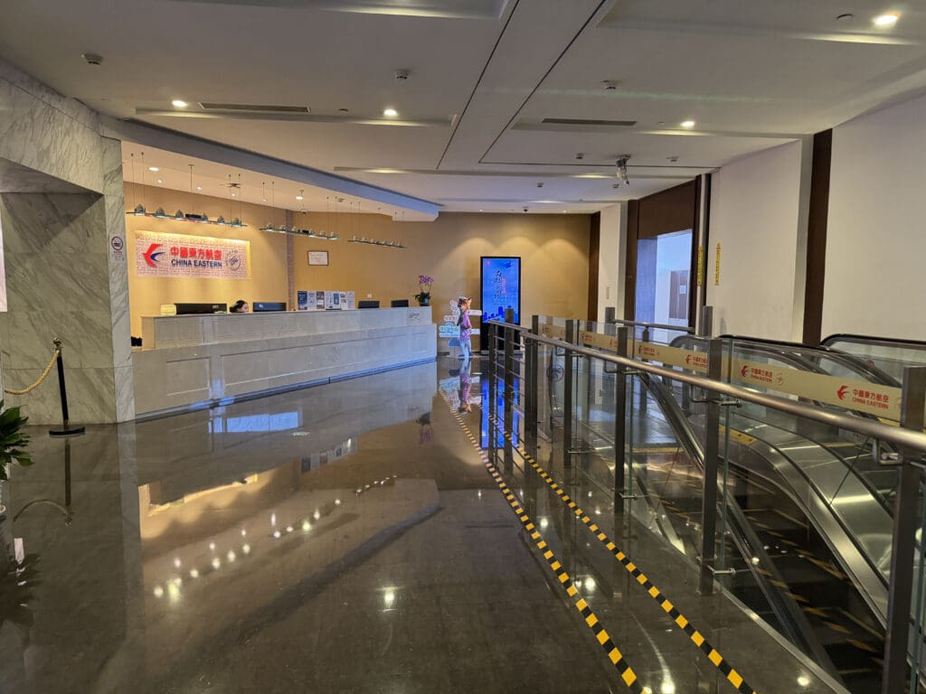 a lobby with a glass railing and a metal railing