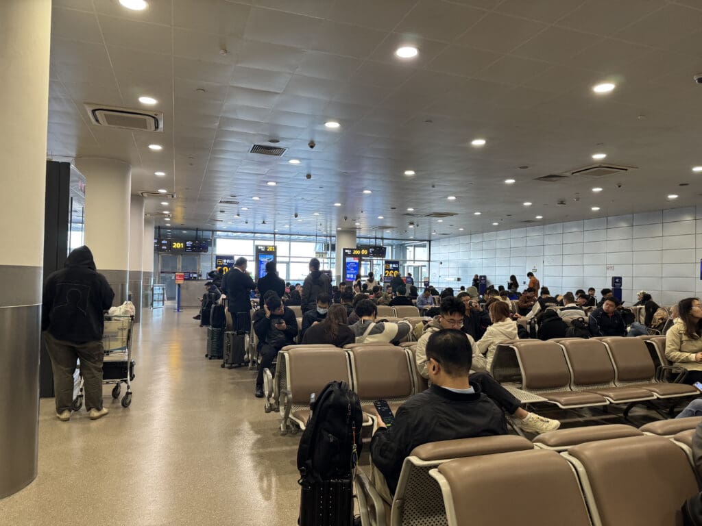 a group of people sitting in chairs in an airport