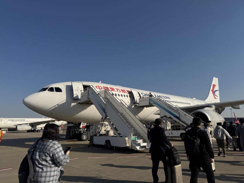people boarding an airplane at an airport