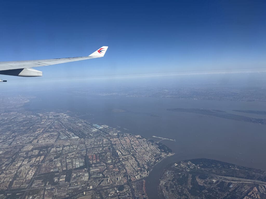 an airplane wing above a body of water