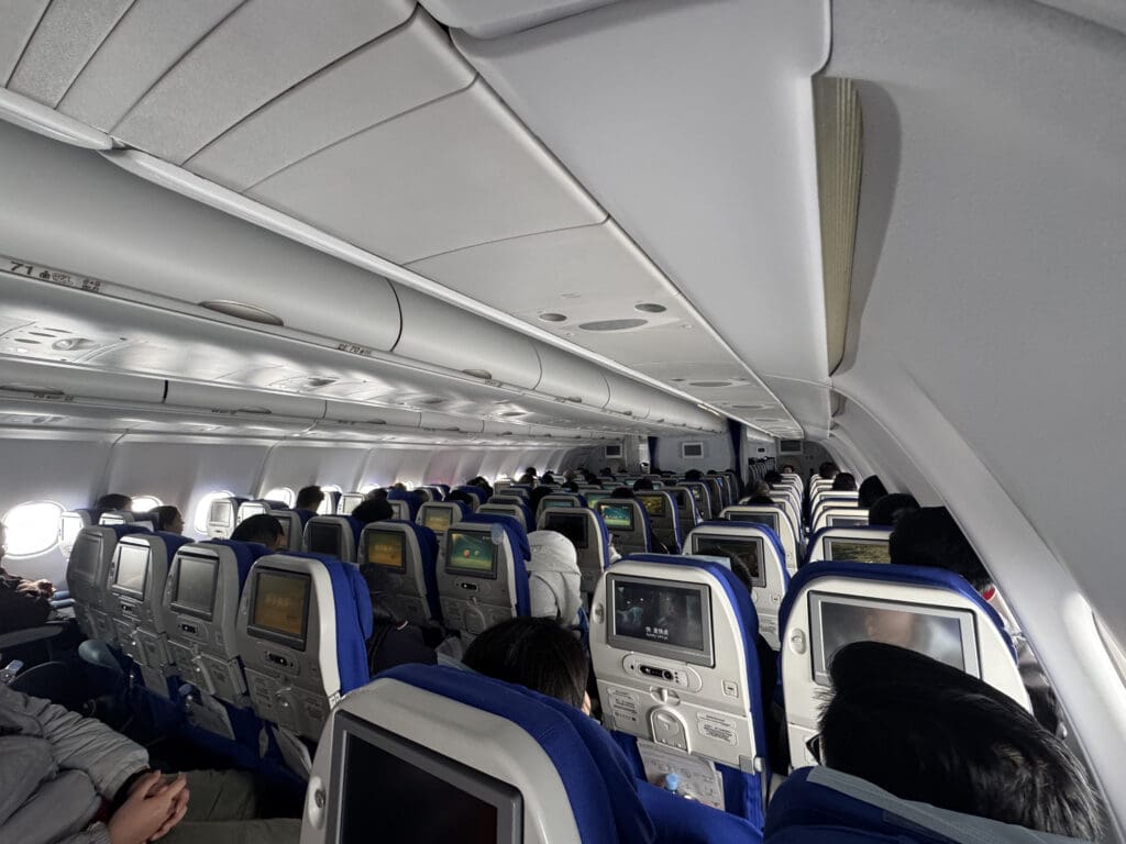 a group of people sitting in an airplane