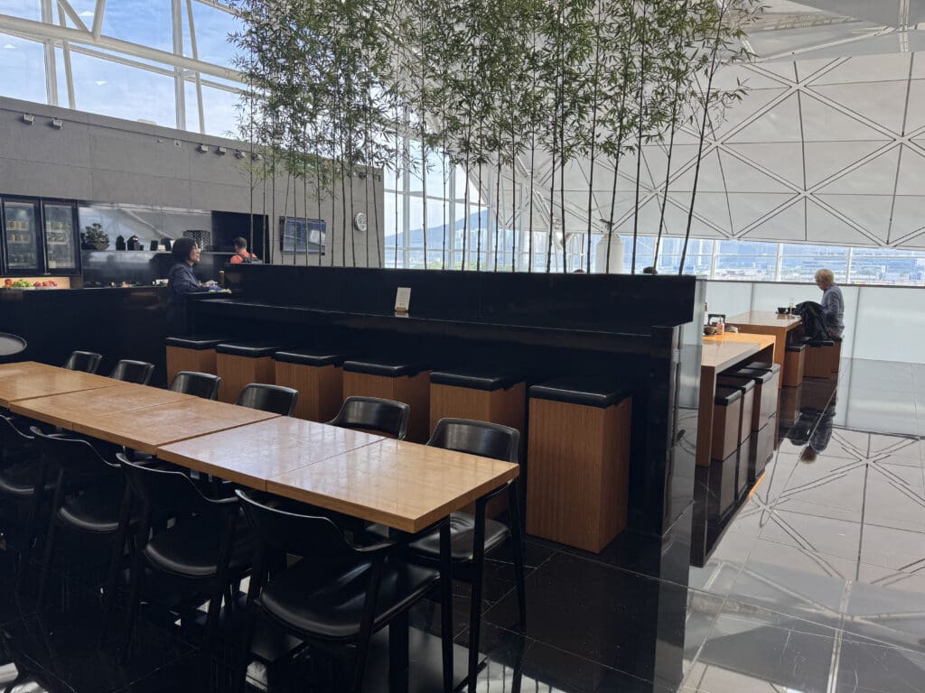 a room with tables and chairs and a tree