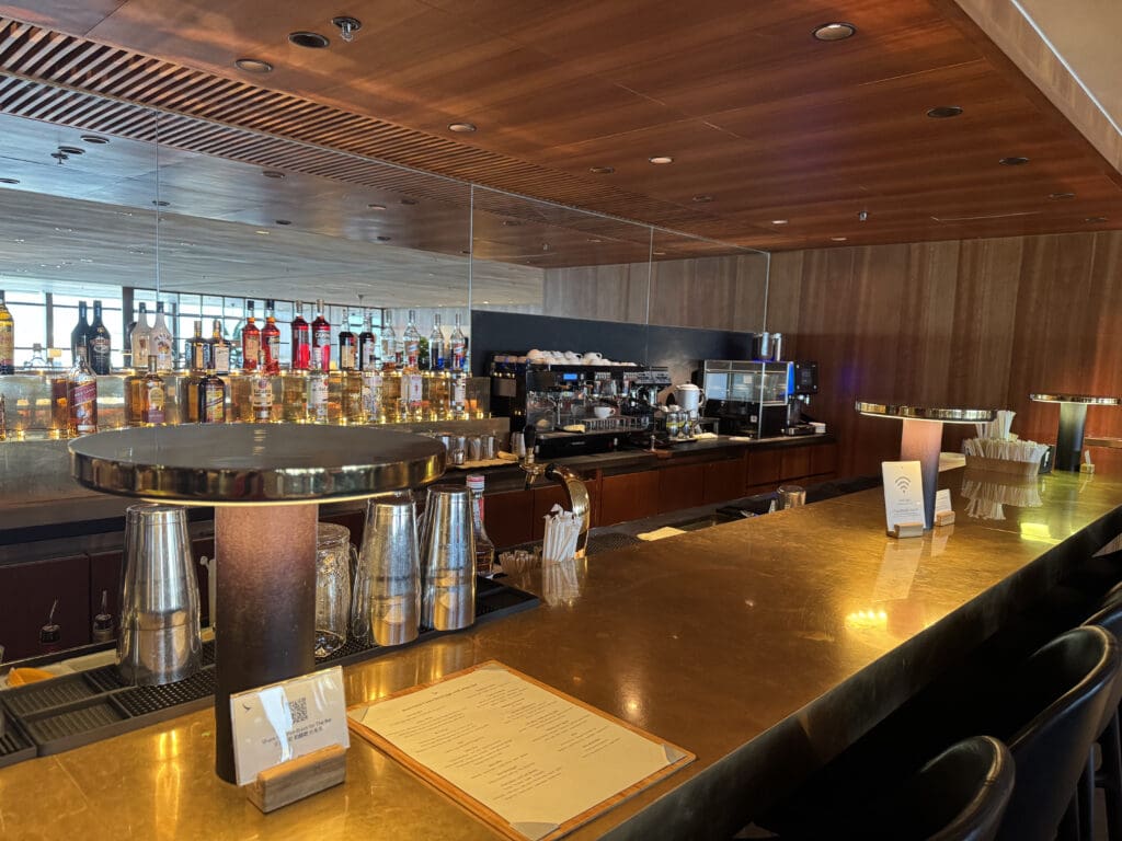 a bar with a counter and a few bottles of liquor