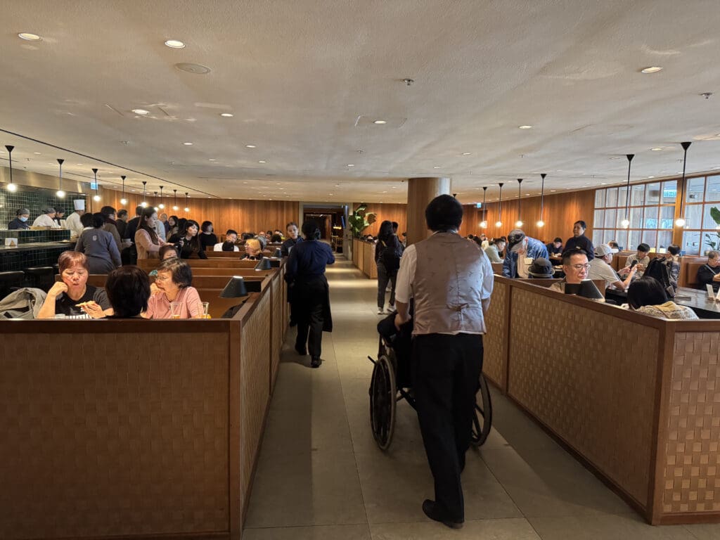 a group of people in a room with a wheelchair