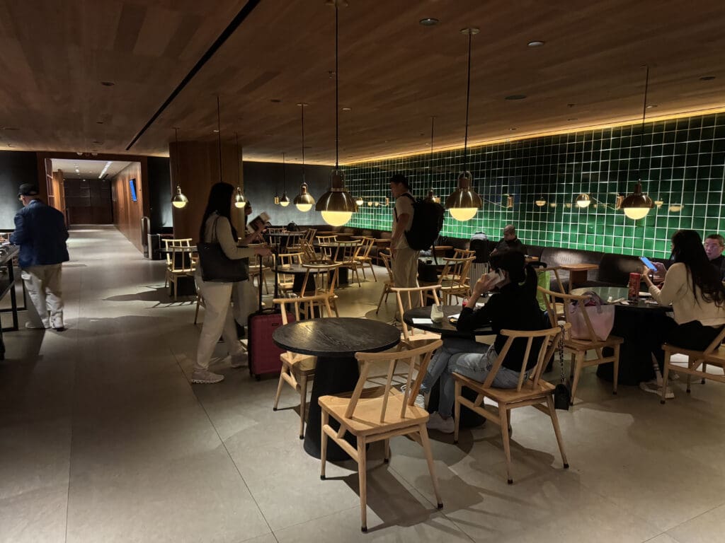 a group of people in a room with tables and chairs