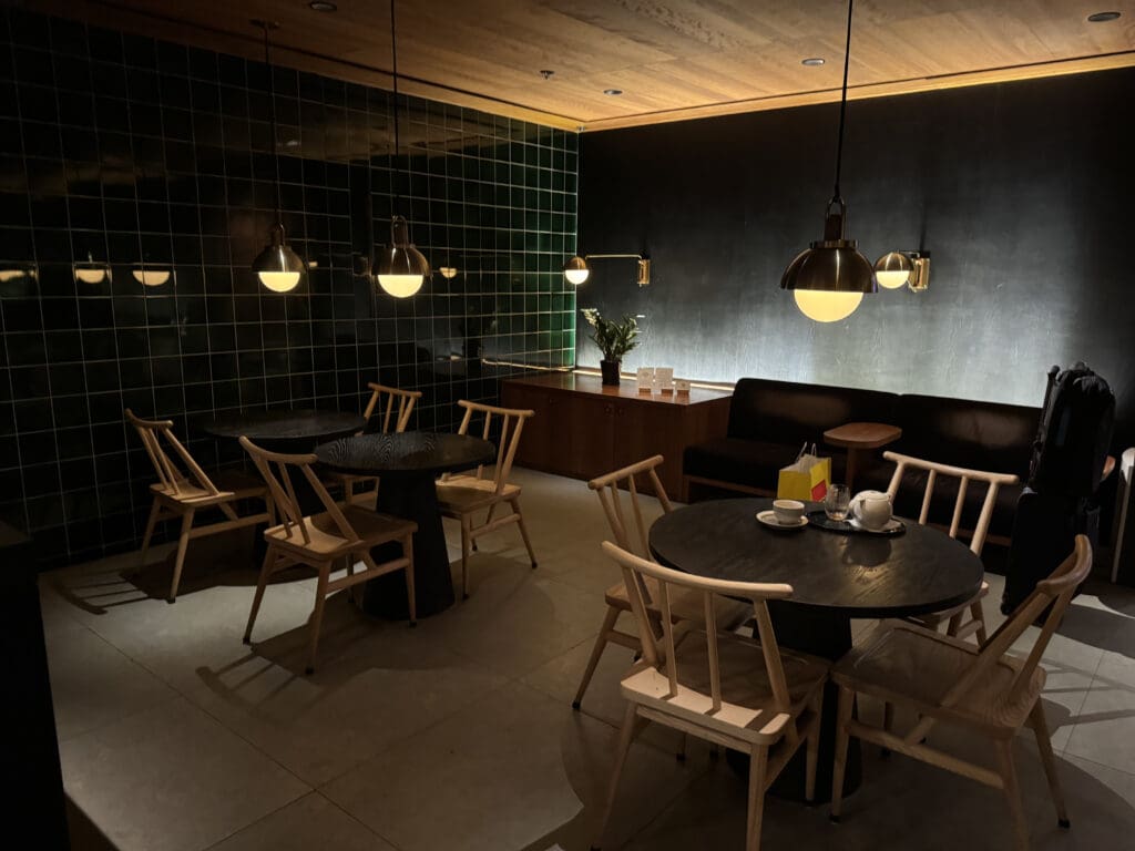 a room with a black tile wall and a black tile floor