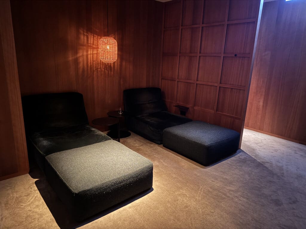 a room with two chairs and a lamp