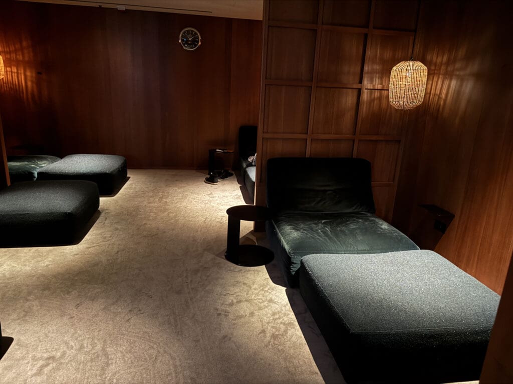 a room with a few chairs and a lamp