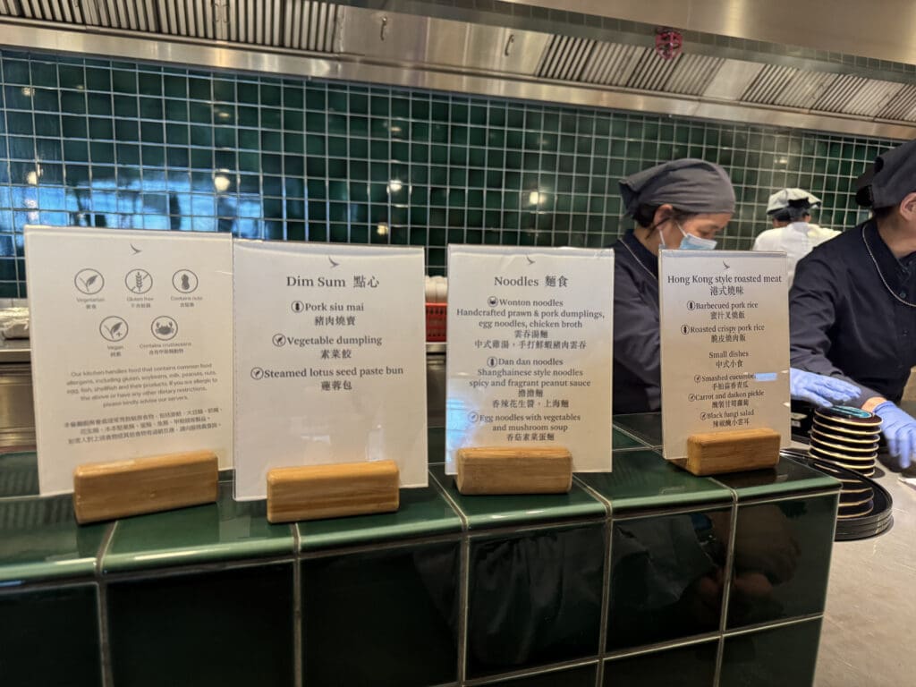 a group of people standing behind a counter with signs